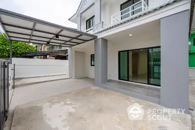 Modern two-story house with spacious carport and sleek exterior design