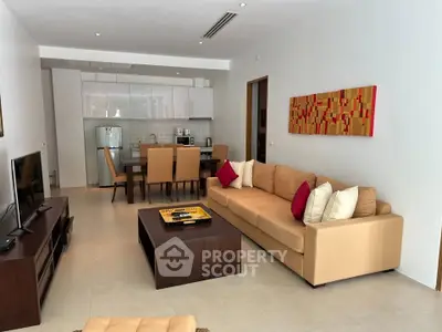 Modern open-plan living room with stylish furniture and integrated kitchen, perfect for contemporary living.
