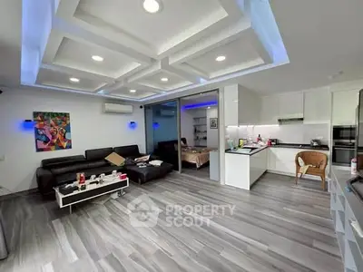 Modern open-plan living room with sleek kitchen and stylish decor