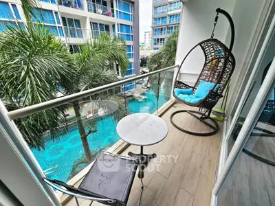 Charming balcony with pool view, featuring a cozy hanging chair and elegant table, perfect for relaxation.