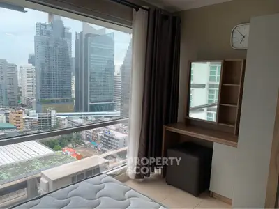 Modern bedroom with city view and stylish furniture in high-rise apartment.