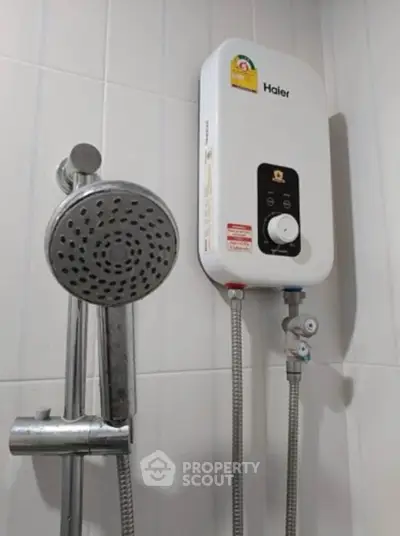 Modern bathroom with water heater and showerhead, ideal for comfortable living.
