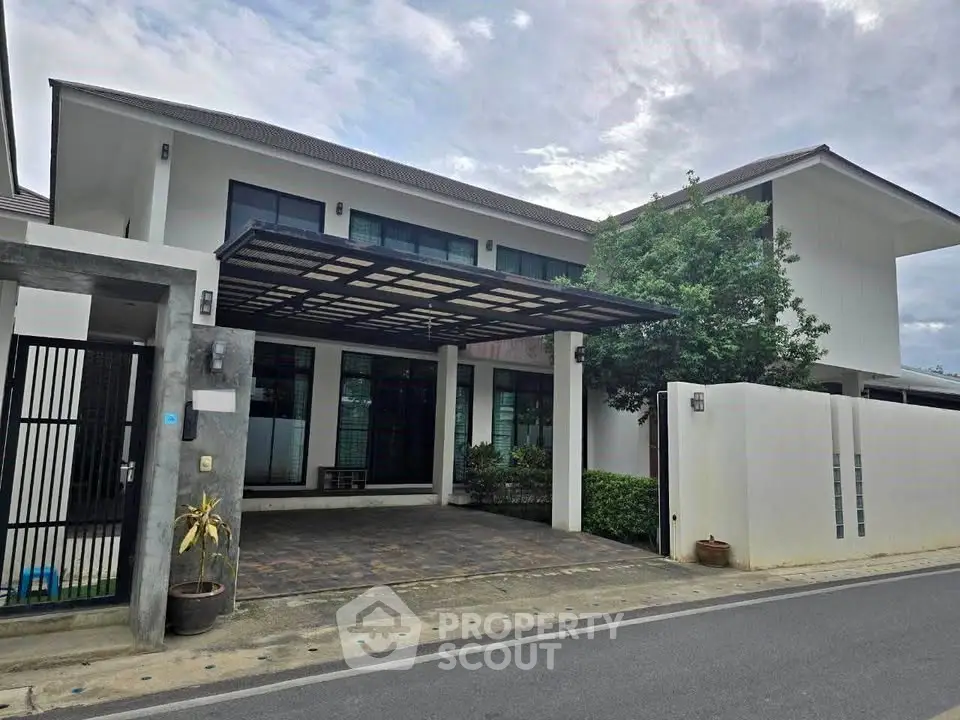 Modern two-story house with sleek design and spacious driveway in a serene neighborhood.