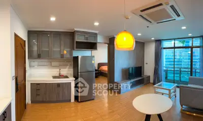 Modern open-layout living room with kitchen and balcony view