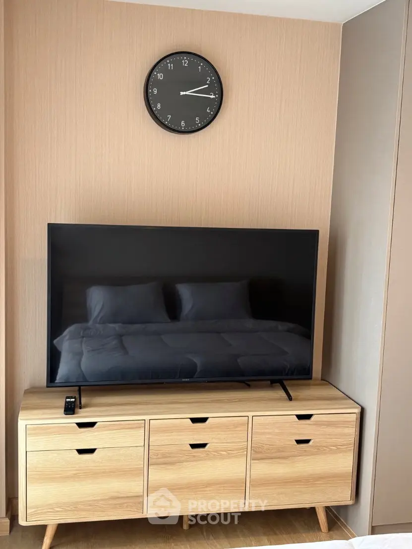 Modern living room with sleek TV setup and stylish wooden cabinet