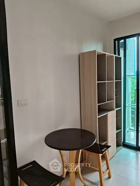 Cozy corner with table and chairs near balcony in modern apartment