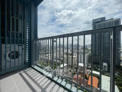 Stunning city view from modern high-rise balcony with sleek railing design.