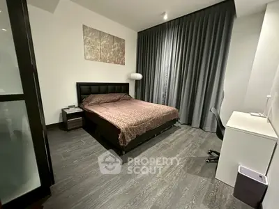 Modern bedroom with sleek design, featuring a comfortable bed, stylish decor, and functional workspace.