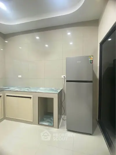 Modern kitchen with sleek fridge and minimalist design