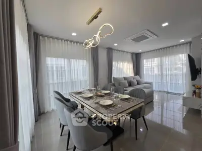 Modern living room with elegant dining area and stylish lighting