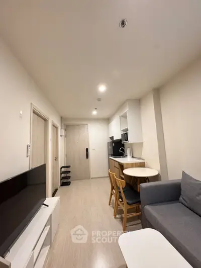 Modern apartment interior with cozy living area and compact kitchen