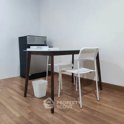 Minimalist dining area with modern table and chairs on wooden flooring