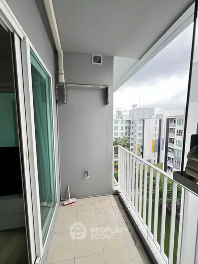 Modern apartment balcony with city view and sliding glass doors