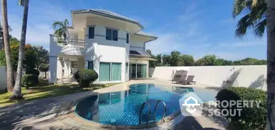 Luxurious villa with private pool and lush garden in tropical paradise setting.