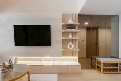Modern living room with sleek TV setup and stylish decor in a contemporary apartment.