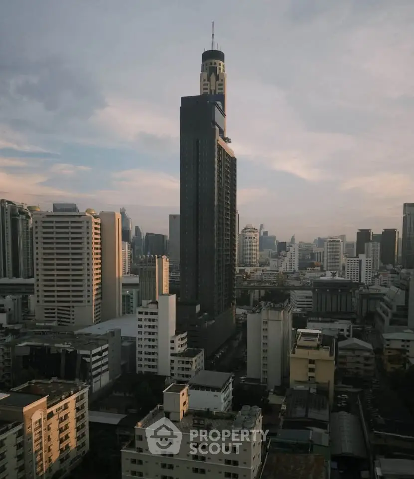 Stunning cityscape view featuring a prominent skyscraper amidst urban skyline at dusk.