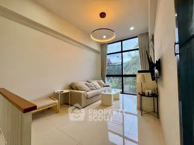 Modern living room with large window and stylish lighting in a cozy apartment.