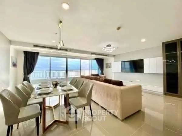 Spacious living room with stunning ocean view and elegant dining area