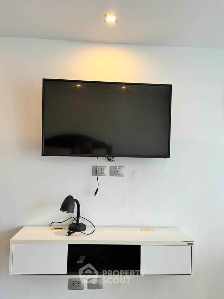 Modern living room with wall-mounted TV and sleek console table