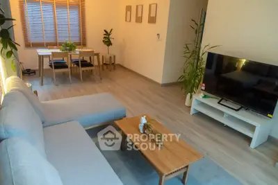 Modern living room with stylish furniture and large TV, perfect for relaxation and entertainment.