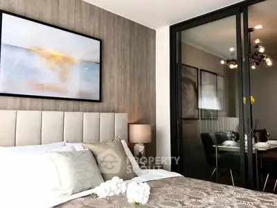 Modern bedroom with elegant decor and glass partition to dining area.