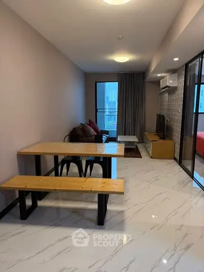 Modern living room with sleek furniture and city view balcony.