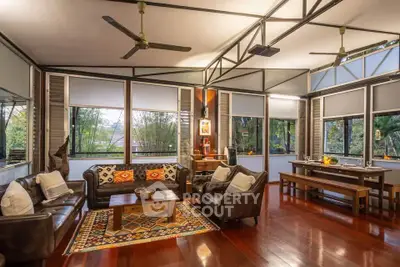 Spacious living room with elegant decor and large windows offering scenic views.