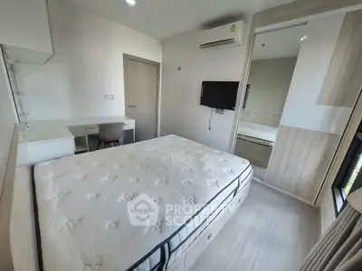 Modern bedroom with sleek design, featuring a comfortable bed, built-in wardrobe, and wall-mounted TV.