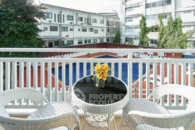 Charming balcony with pool view, perfect for relaxation and entertaining guests.