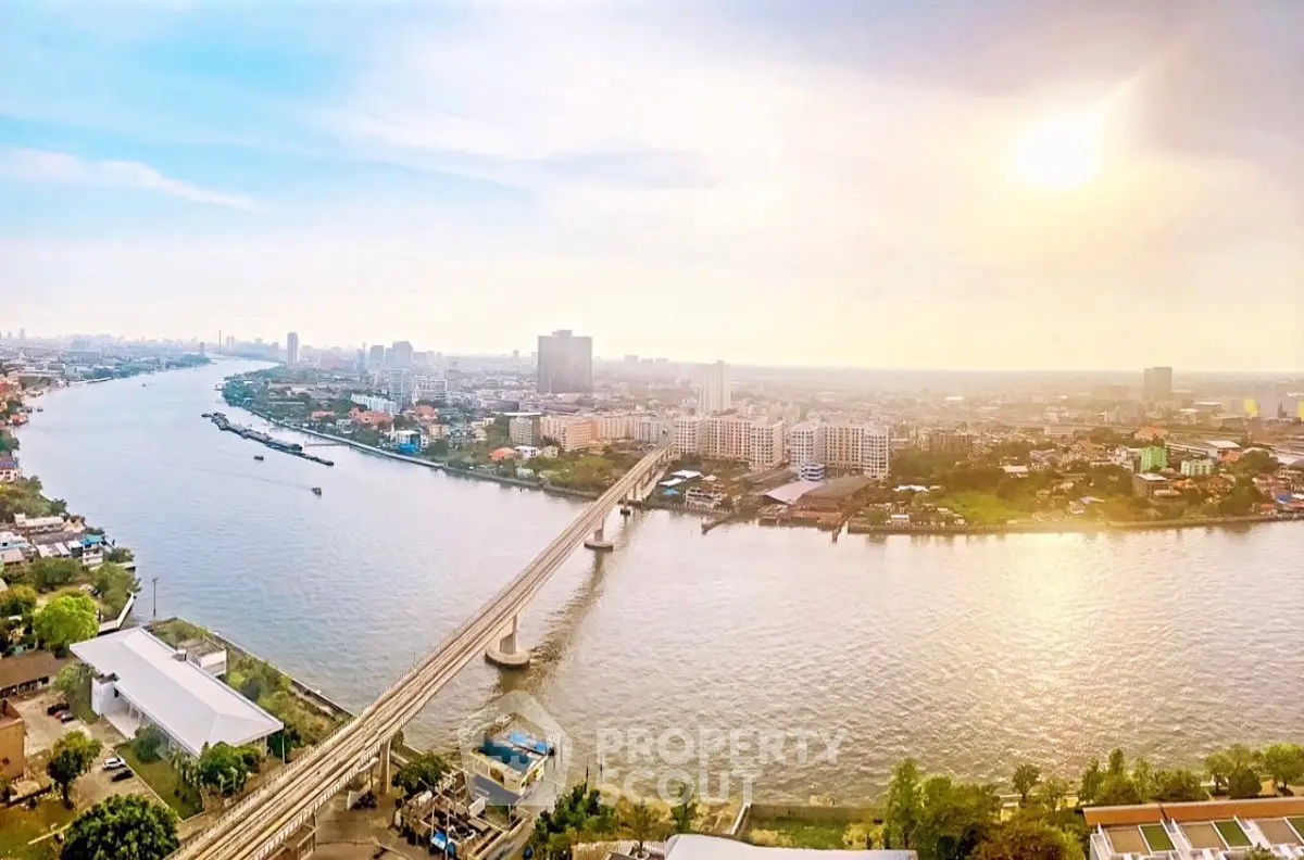 Stunning panoramic river view from high-rise apartment, showcasing city skyline and serene waterway.