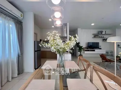 Modern open-plan living and dining area with stylish decor and natural light.