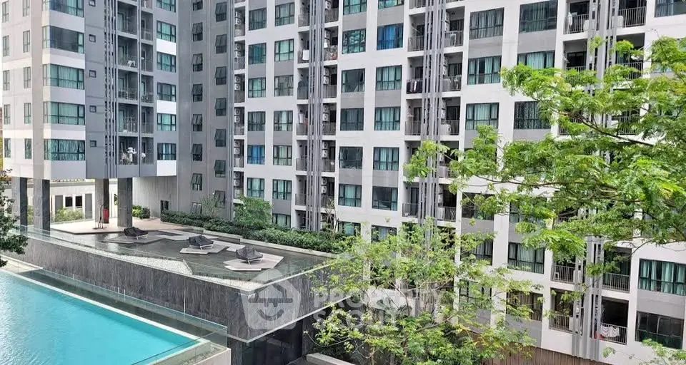 Modern apartment building with pool and lush greenery view