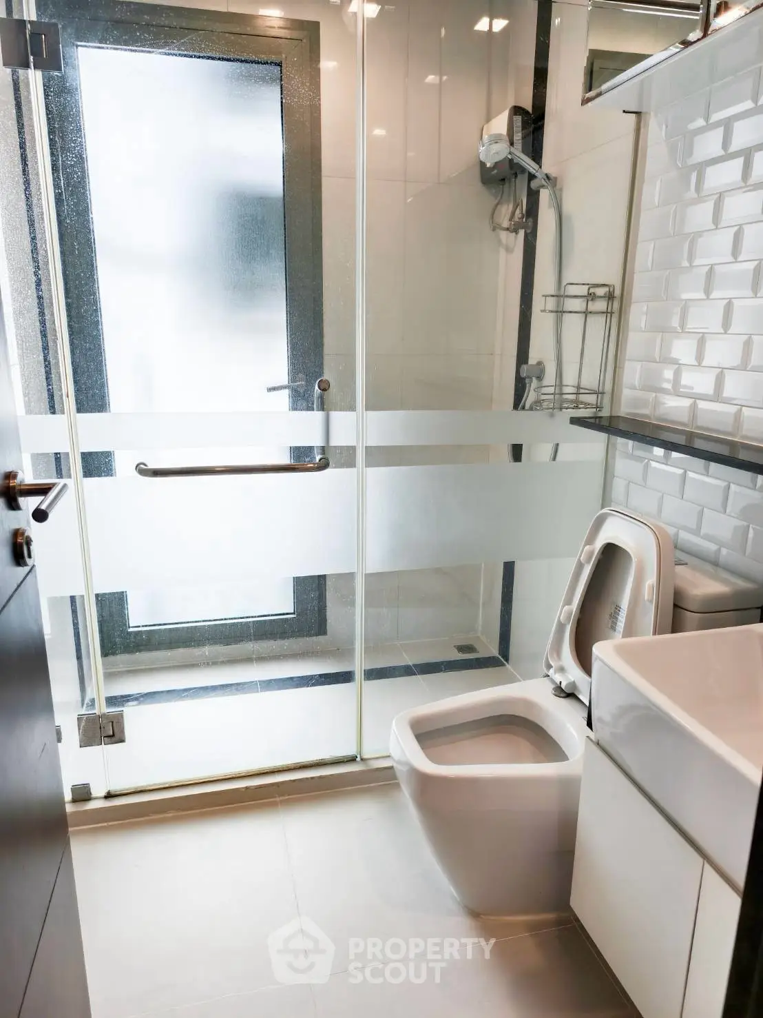 Modern bathroom with sleek design, glass shower door, and contemporary fixtures.