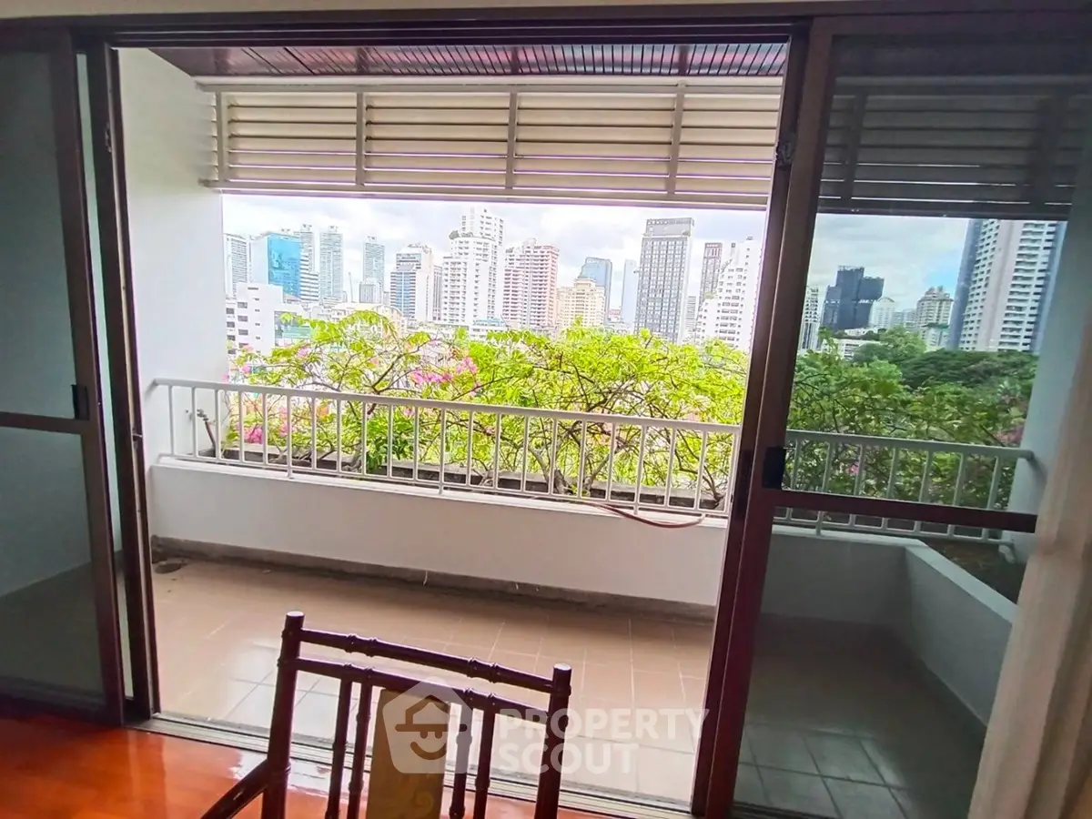 Spacious balcony with stunning city skyline view, perfect for relaxation and enjoying urban living.
