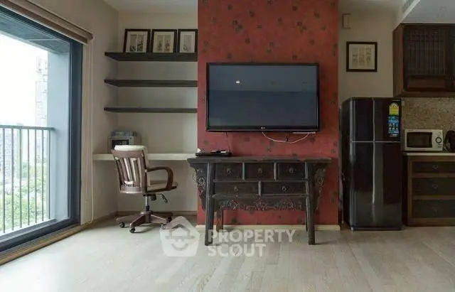 Modern living room with TV, desk, and balcony view