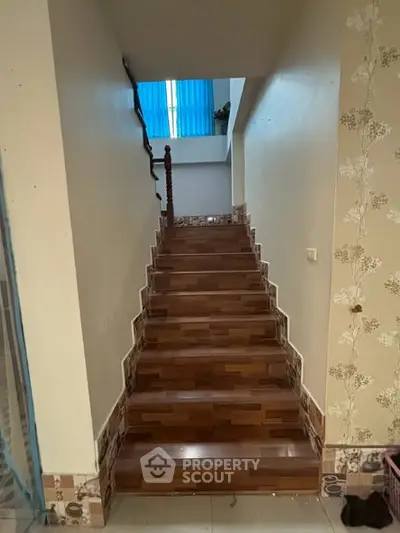 Stylish staircase with wooden steps and decorative wall accents in a modern home interior.