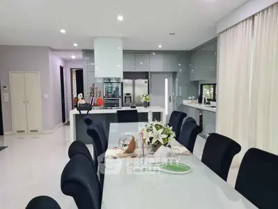Modern dining room with sleek kitchen and elegant decor