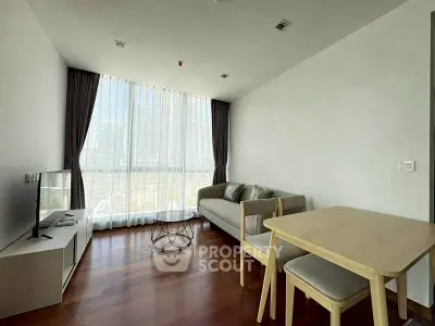 Modern living room with large window and wooden flooring