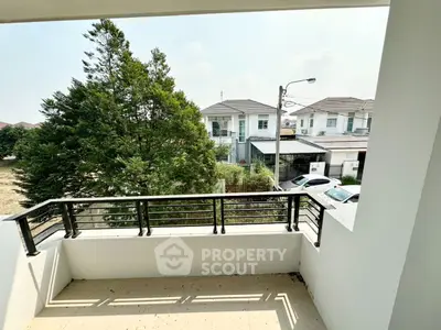 Spacious balcony with scenic view of suburban neighborhood and lush greenery.