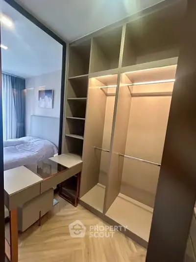Spacious walk-in closet with modern design adjacent to a cozy bedroom.