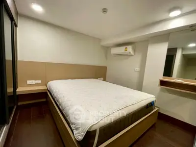 Modern bedroom with cozy bed and built-in air conditioning unit