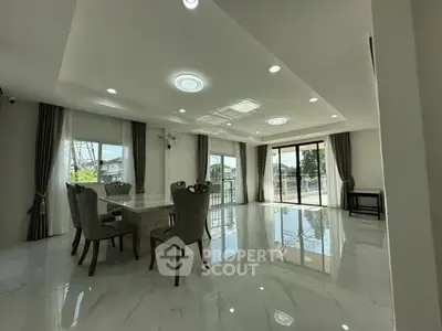 Spacious modern living room with elegant dining area and large windows