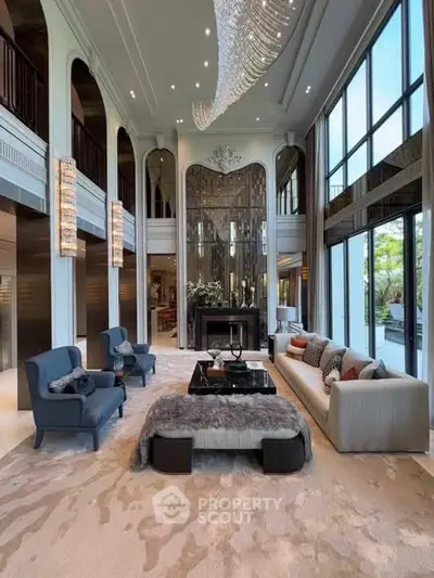 Luxurious high-ceiling living room with elegant decor and large windows