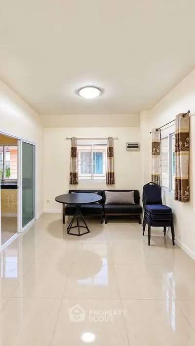 Spacious living room with modern furniture and large windows for natural light.