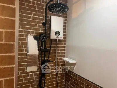 Modern bathroom with stylish brick wall and dual shower heads for a luxurious experience.