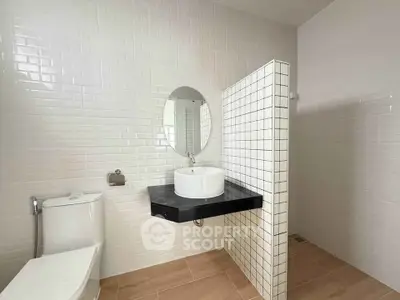Modern minimalist bathroom with sleek white tiles and stylish fixtures