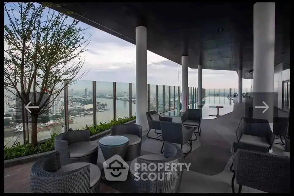 Luxurious rooftop terrace with stunning city and river views, featuring modern outdoor seating and glass railings.