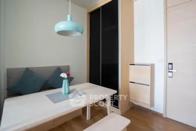 Modern minimalist dining area with sleek furniture and stylish pendant light