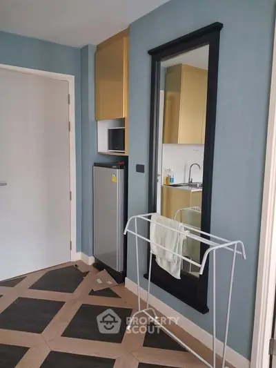 Modern apartment interior with compact kitchen and stylish flooring
