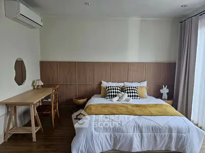 Cozy bedroom with stylish decor and natural light, perfect for relaxation and comfort.